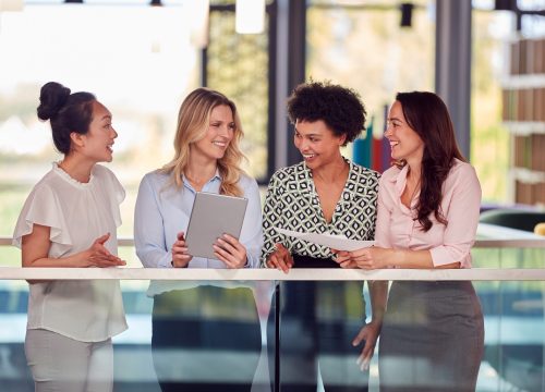 Multi-cultural,Female,Business,Team,With,Digital,Tablet,Meeting,Inside,Modern Multi-cultural,Female,Business,Team,With,Digital,Tablet,Meeting,Inside,Modern